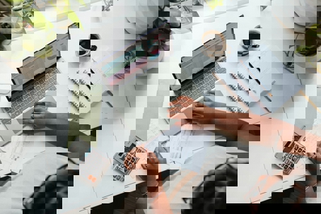 at computer with calculator